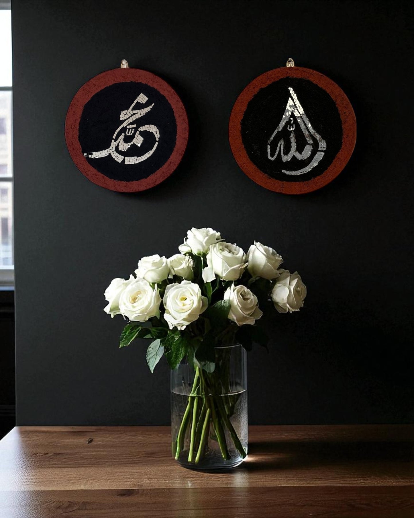 Islamic mosaic calligraphy mirror set of Allah and Muhammad showcased on a black wall and white roses vase on the light brown table