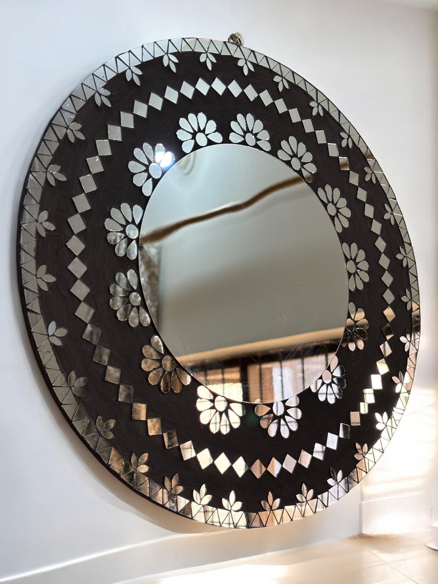 Detailed shot of mosaic craftsmanship on handcrafted mirror wall art