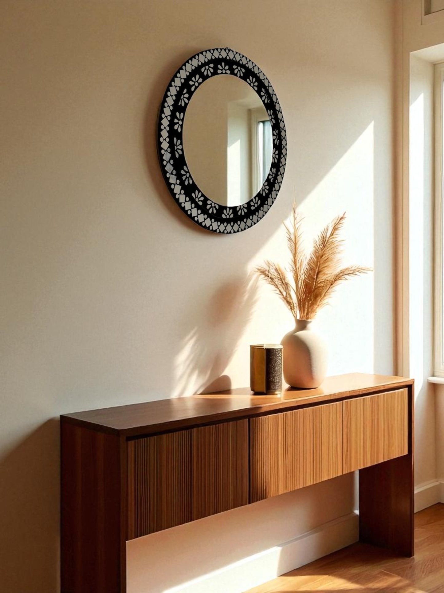 Elegant black floral mosaic mirror styled in a luxury entryway with dark wood and brass decor elements.