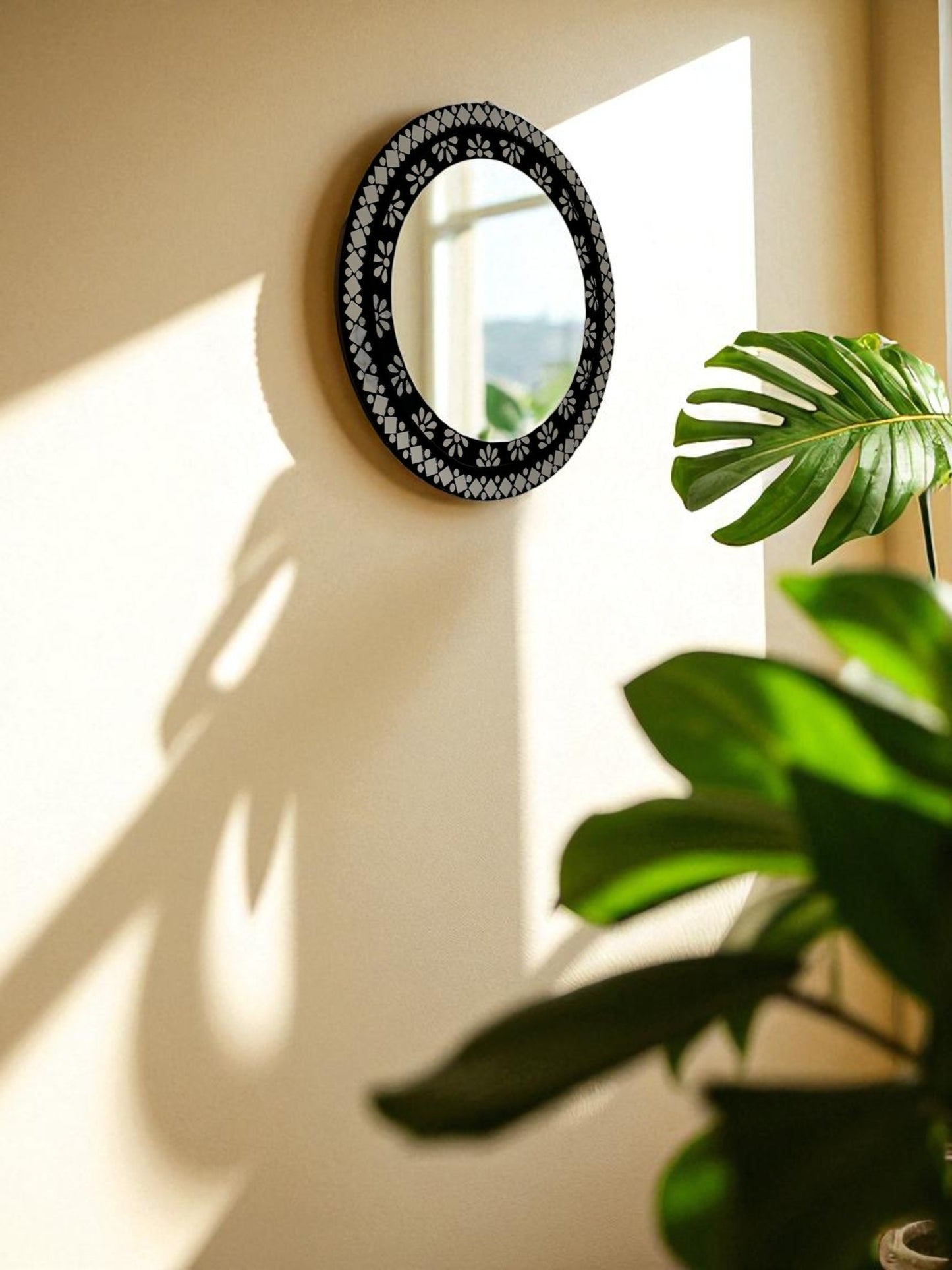 Modern round mosaic wall mirror featured in a minimalist living space with warm, soft lighting.