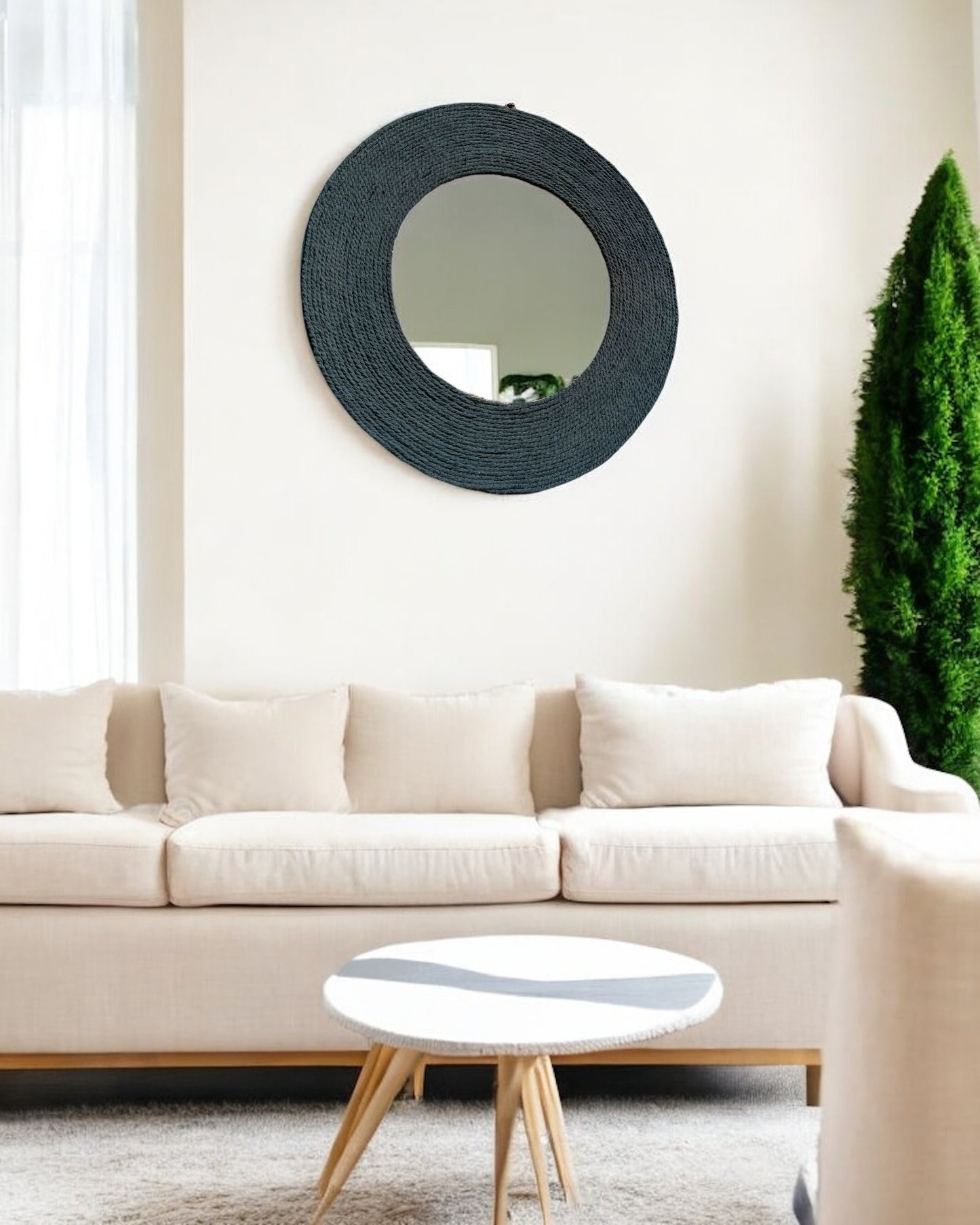 Blue Haze rope mirror wall art displayed at an angle above white sofa in a modern living space