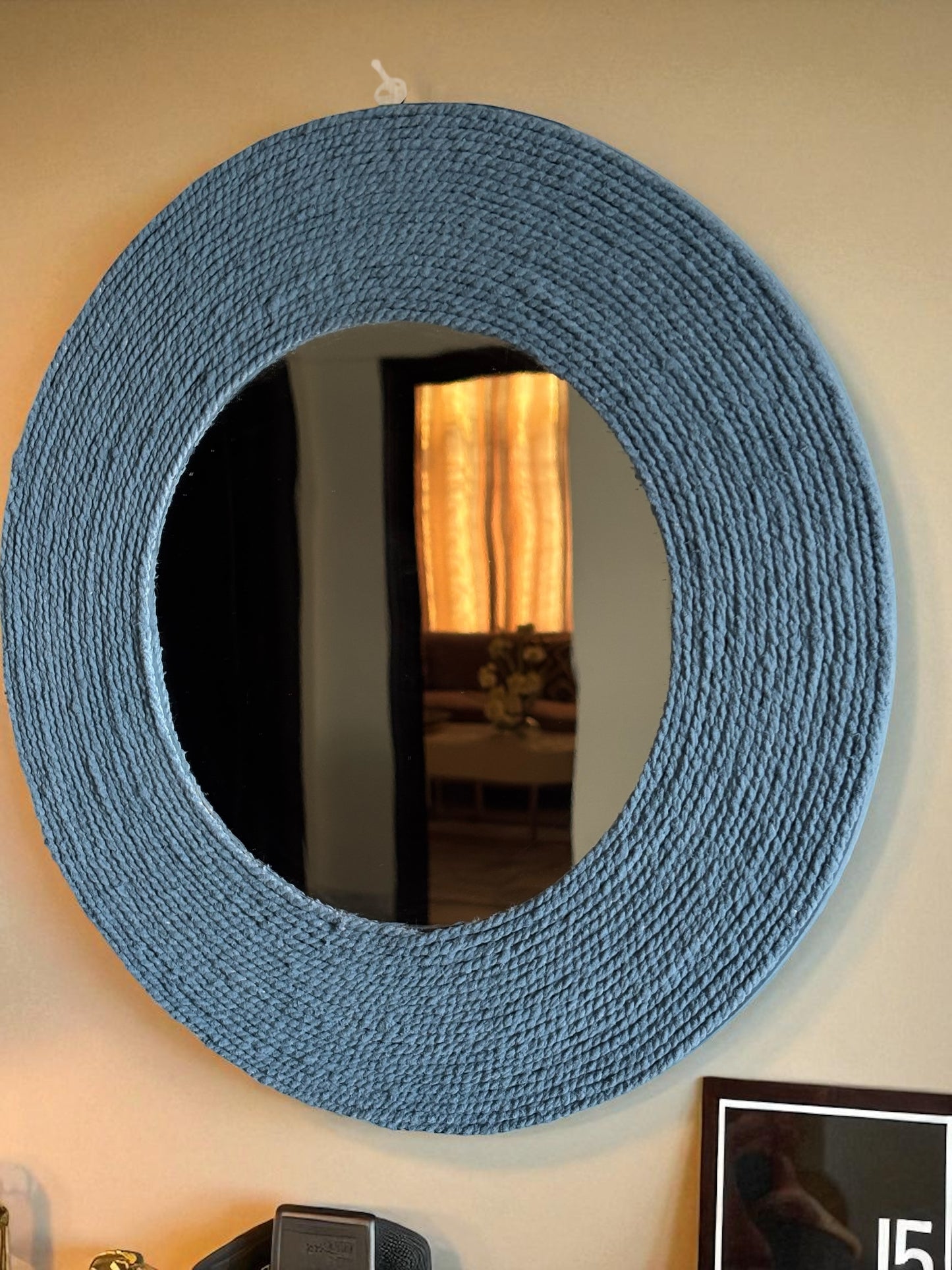 Close-up of handcrafted muted blue rope mirror showing detailed artisan work