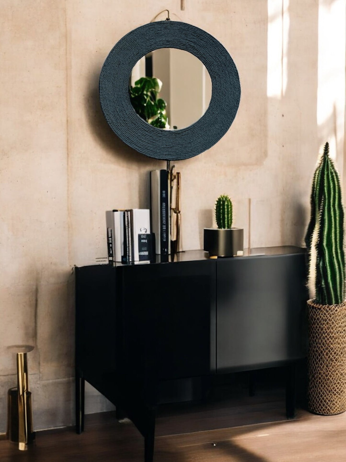 Front view of Blue Haze rope mirror styled above a dark wood table for minimalist decor