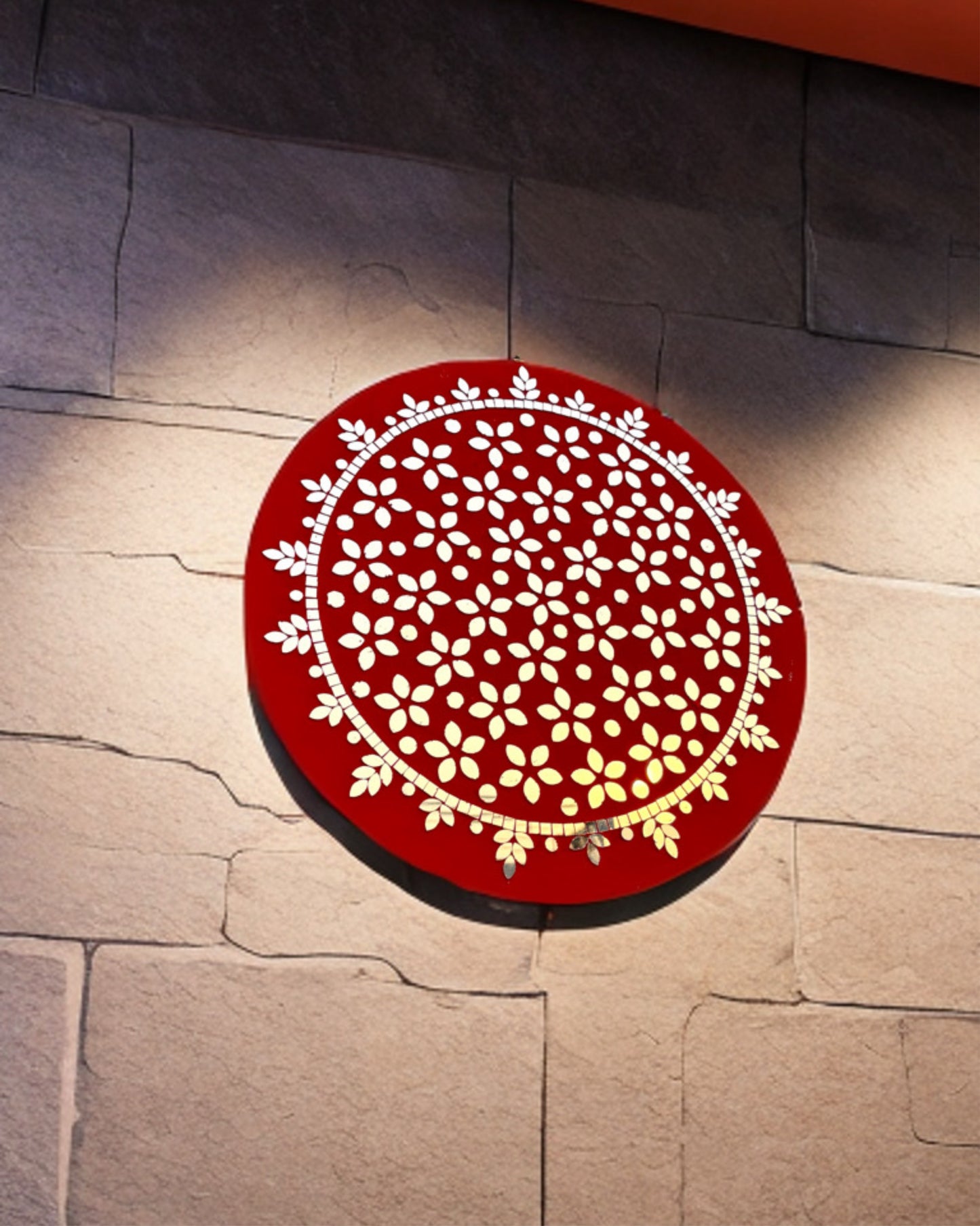 Handmade red floral mosaic round wall art frame by Mirroza, displayed on a stone wall