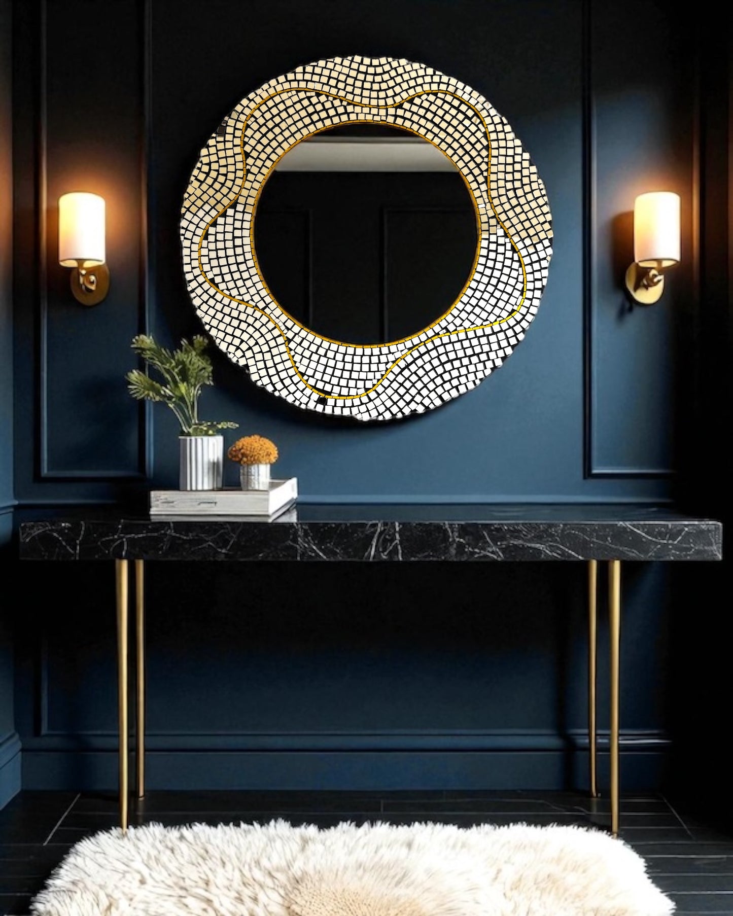 Decorative round mirror mosaic with crystal embellishments on a dark blue wall above a black marble console table.
