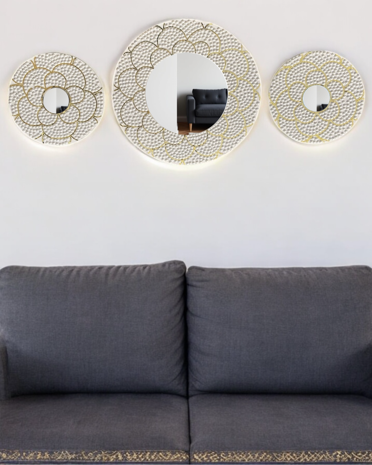 White and gold handcrafted mirror mosaic wall art set on a minimalist wall with a dark gray couch in the background