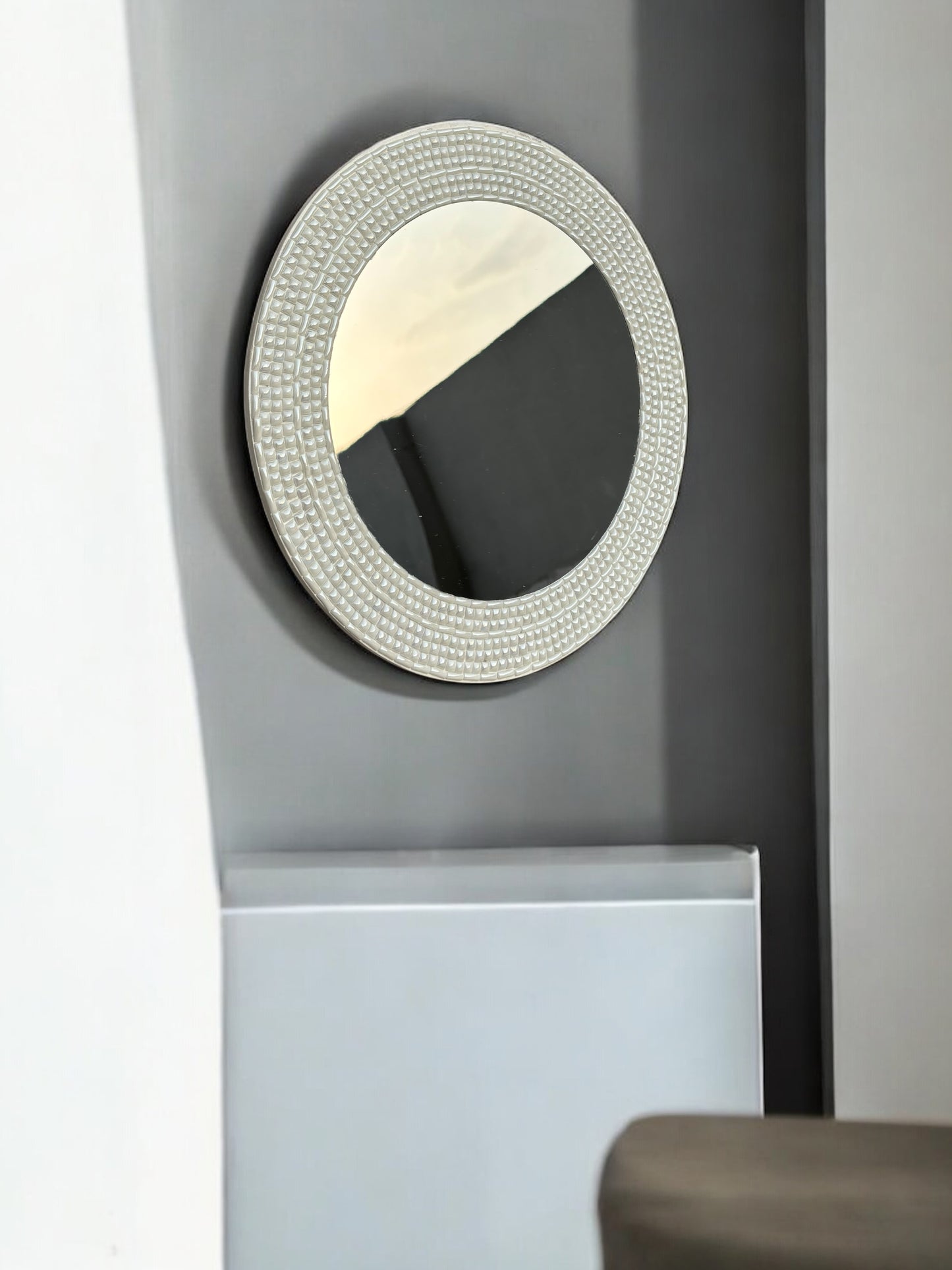 Ivory handcrafted mosaic mirror on dark wall