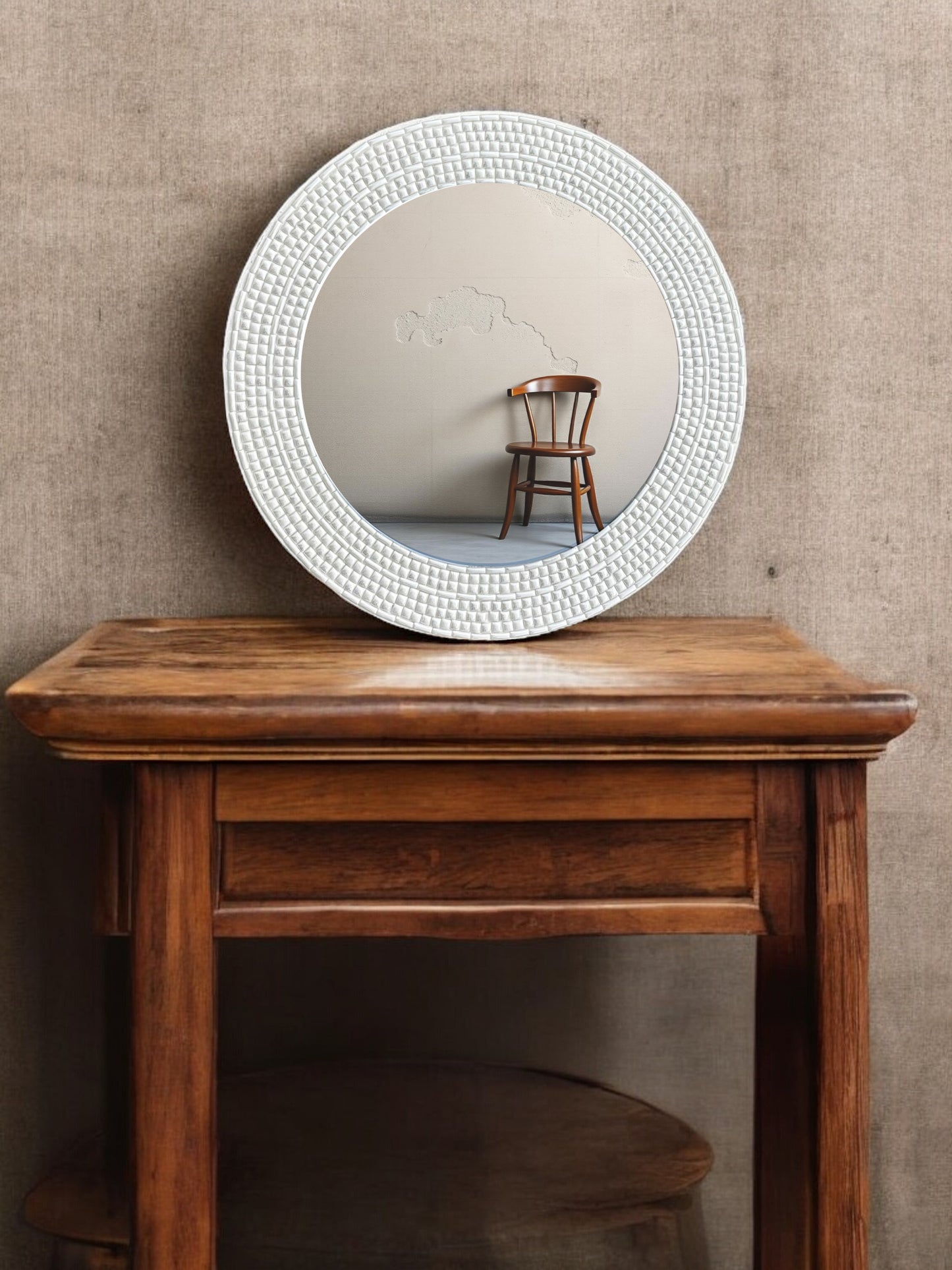 Close-up of handcrafted ivory round mosaic mirror with reflective inlay on wooden table