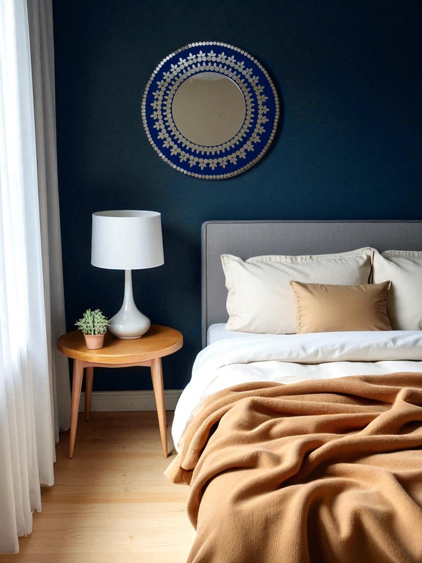 Midnight Blossom handcrafted round mosaic mirror displayed in a minimalist bedroom with neutral tones and soft lighting, adding elegance and depth to the space.