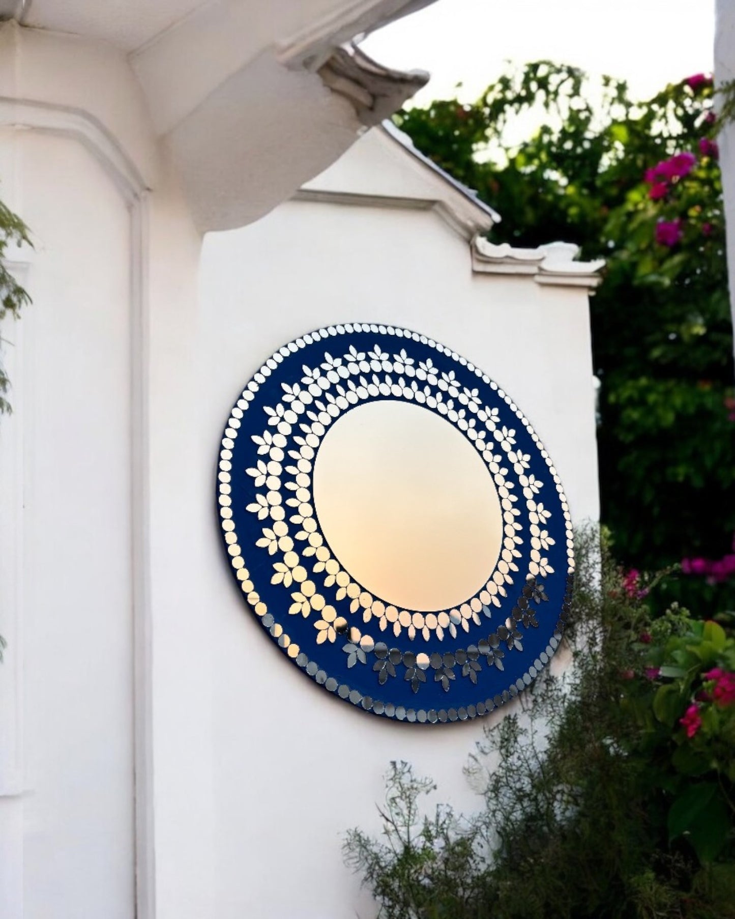 Midnight Blossom mosaic wall mirror displayed on a white wall in patio space, highlighting floral glass inlay and navy background