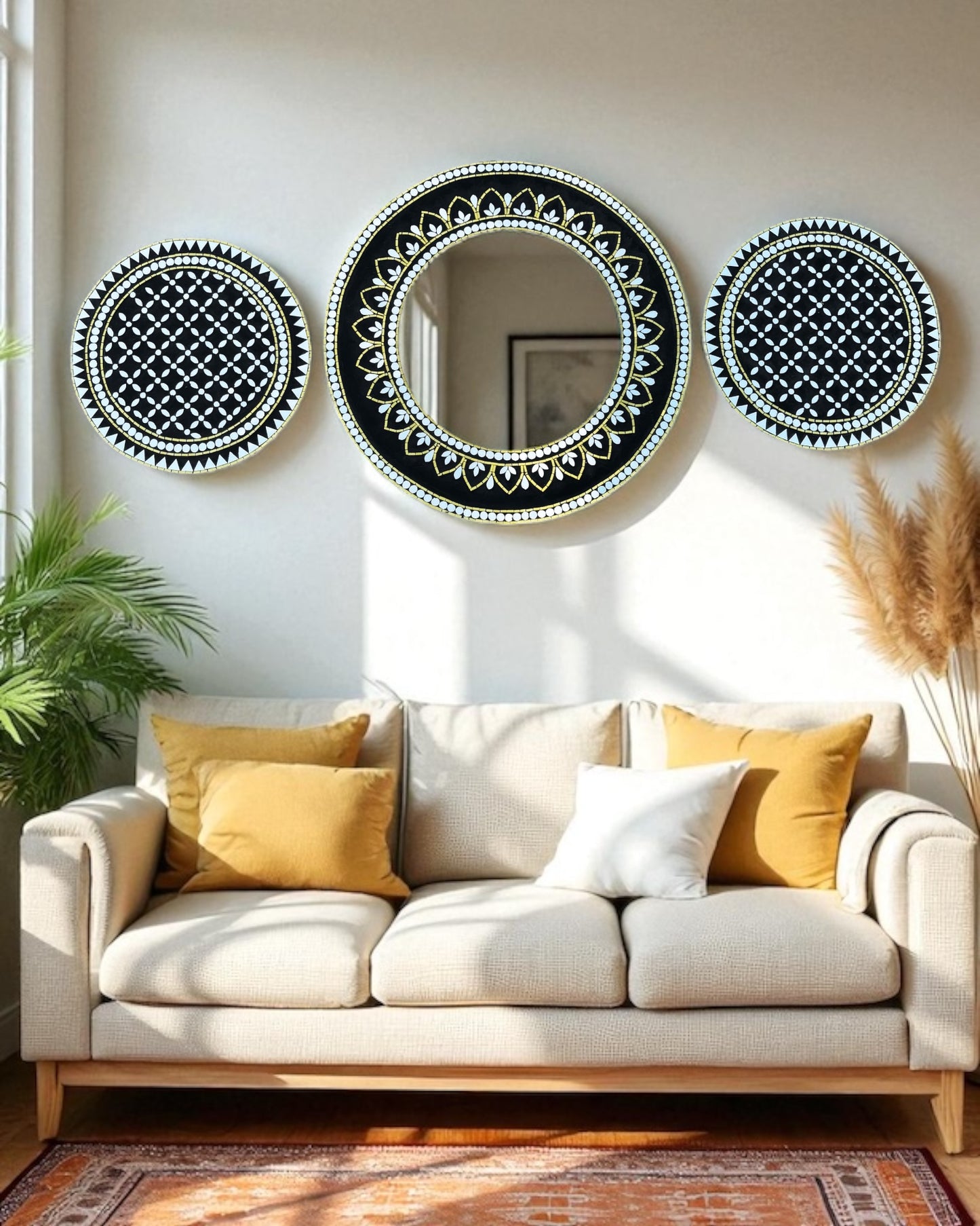 Three mosaic decorative mirrors on a wall above a beige sofa with yellow and white cushions.