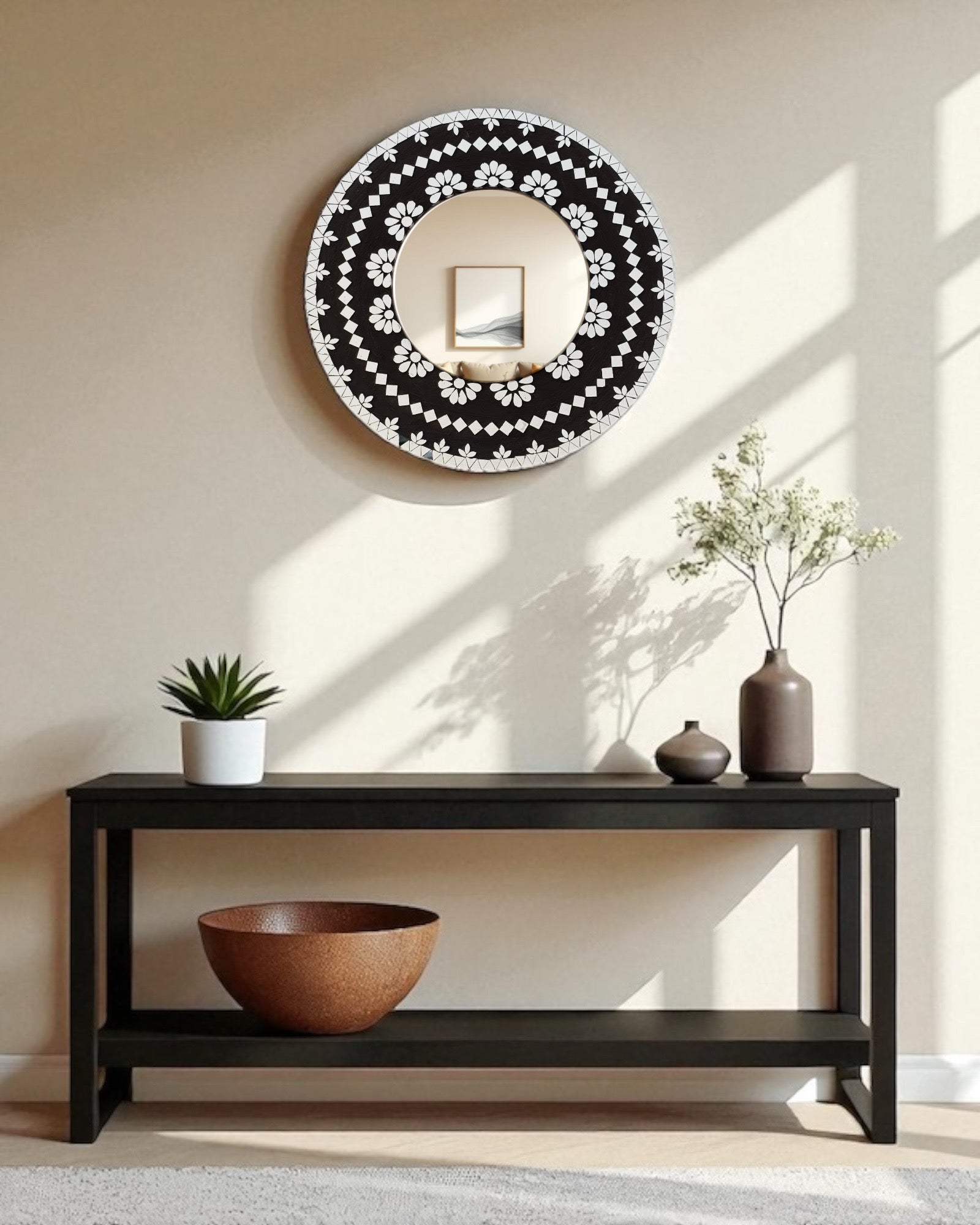 Mirroza black bloom mosaic mirror with floral pattern above a dark wooden console table with decorative items.