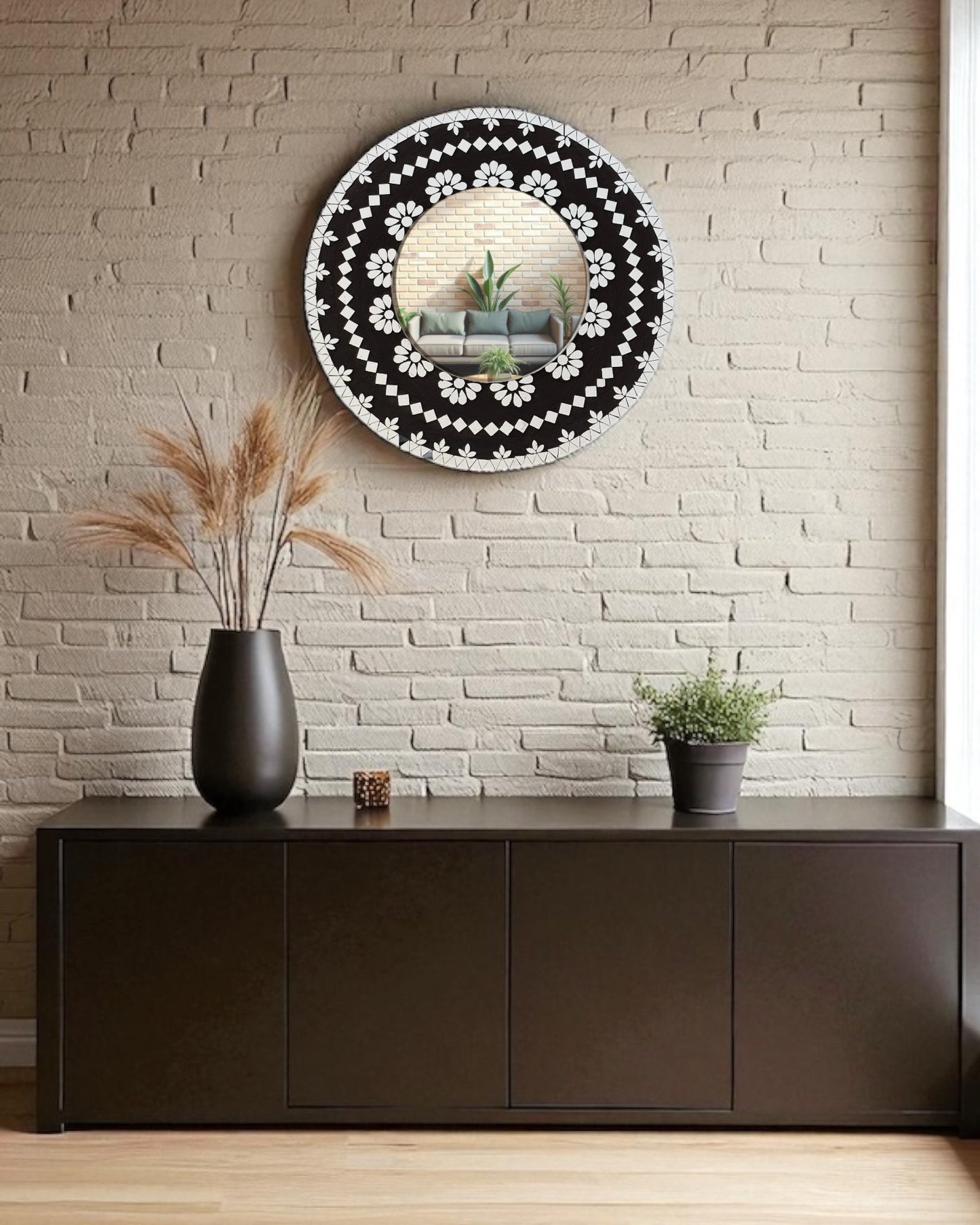 Mirroza black bloom mosaic mirror with floral design on a wall above a dark wooden cabinet.