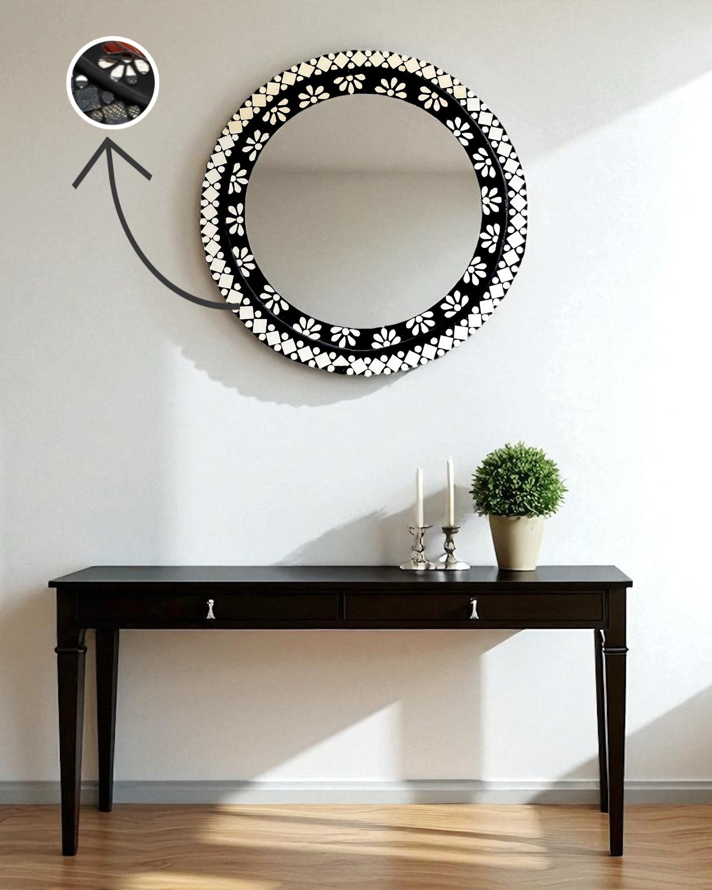 mirroza black mirror with floral patterns on a wall above a black table.