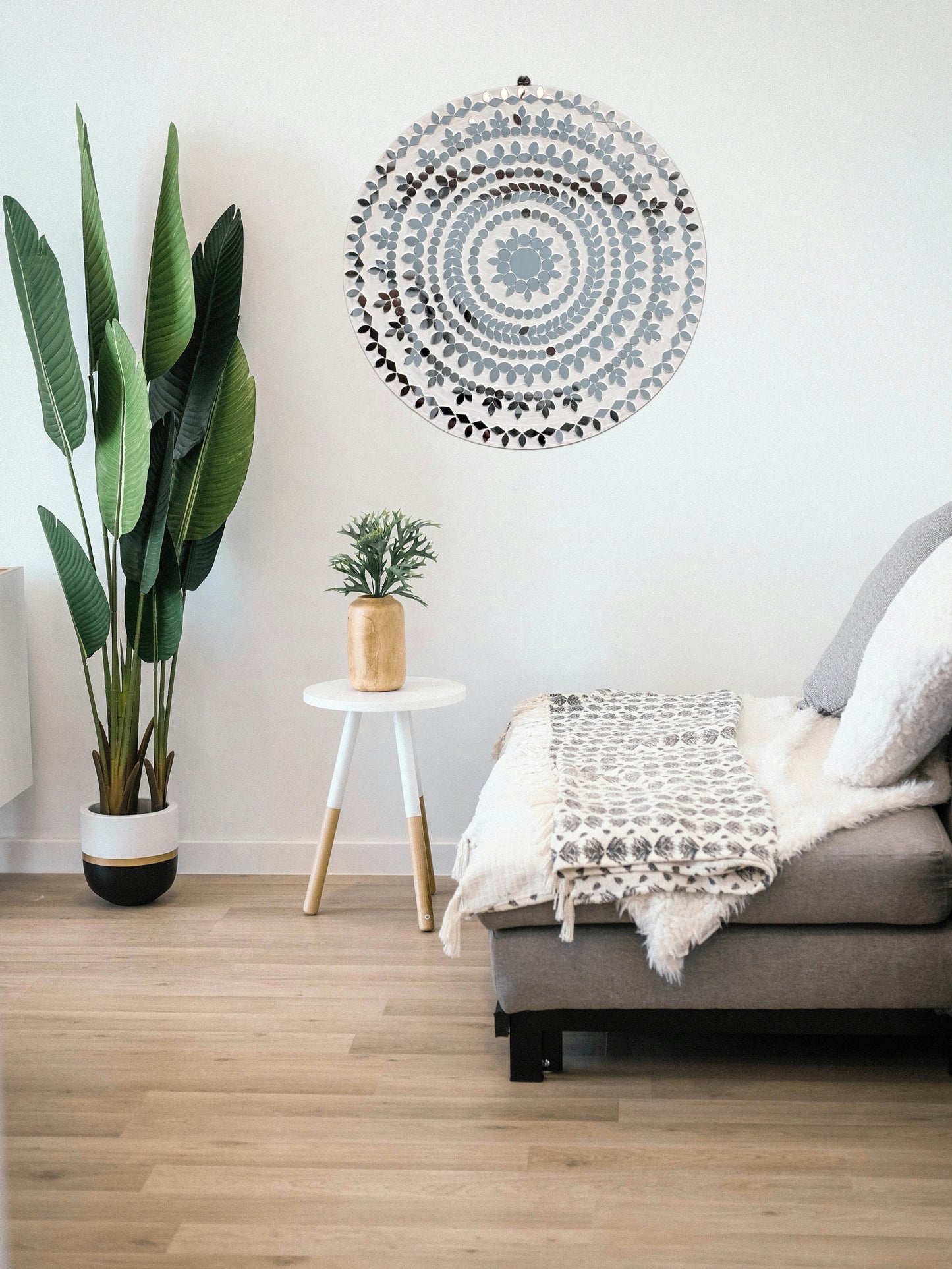White mosaic wall mirror art styled in a modern living room setup