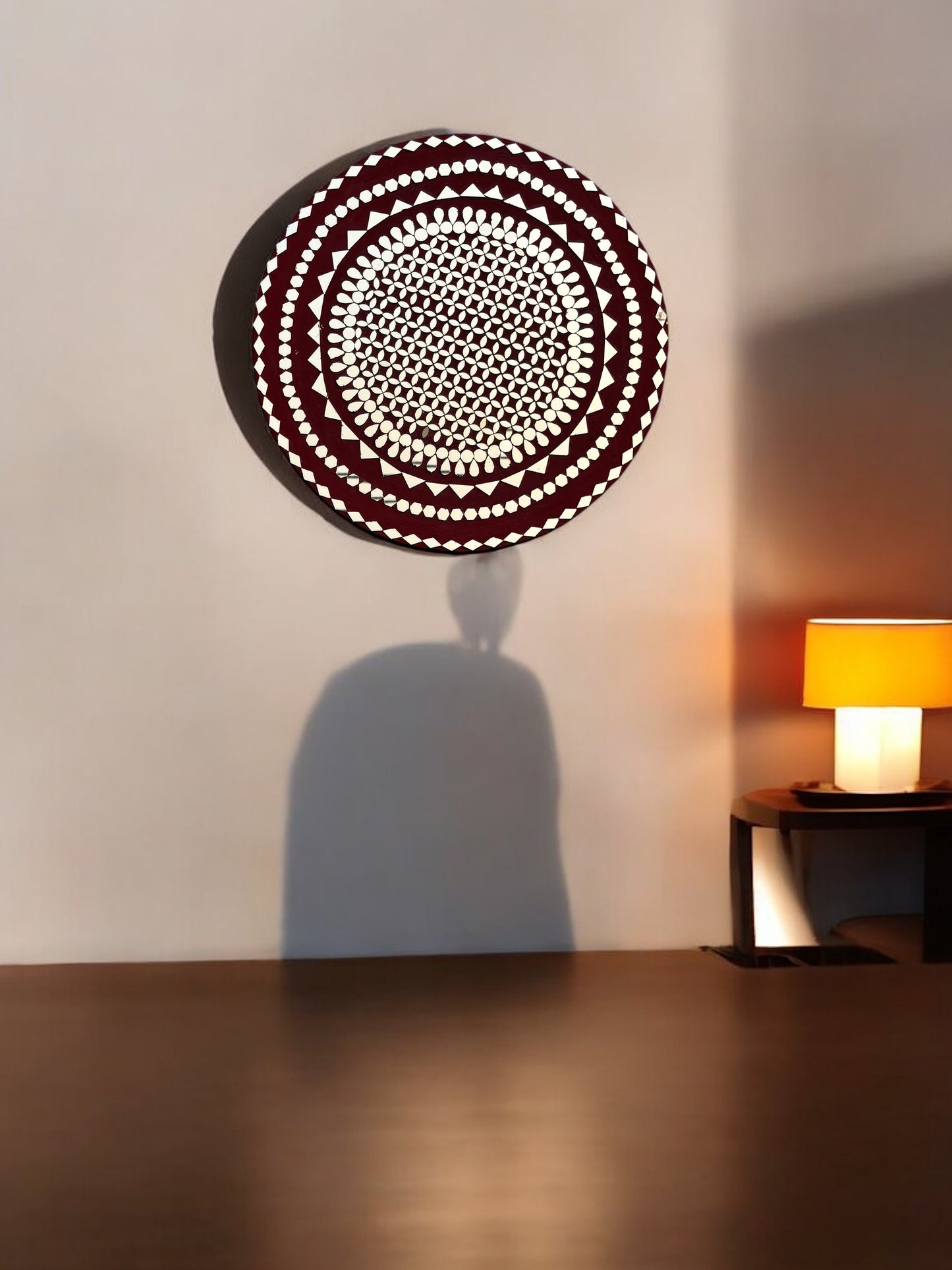 Raspberry mosaic mirror wall art by Mirroza hanging on a beige wall with wooden floor.