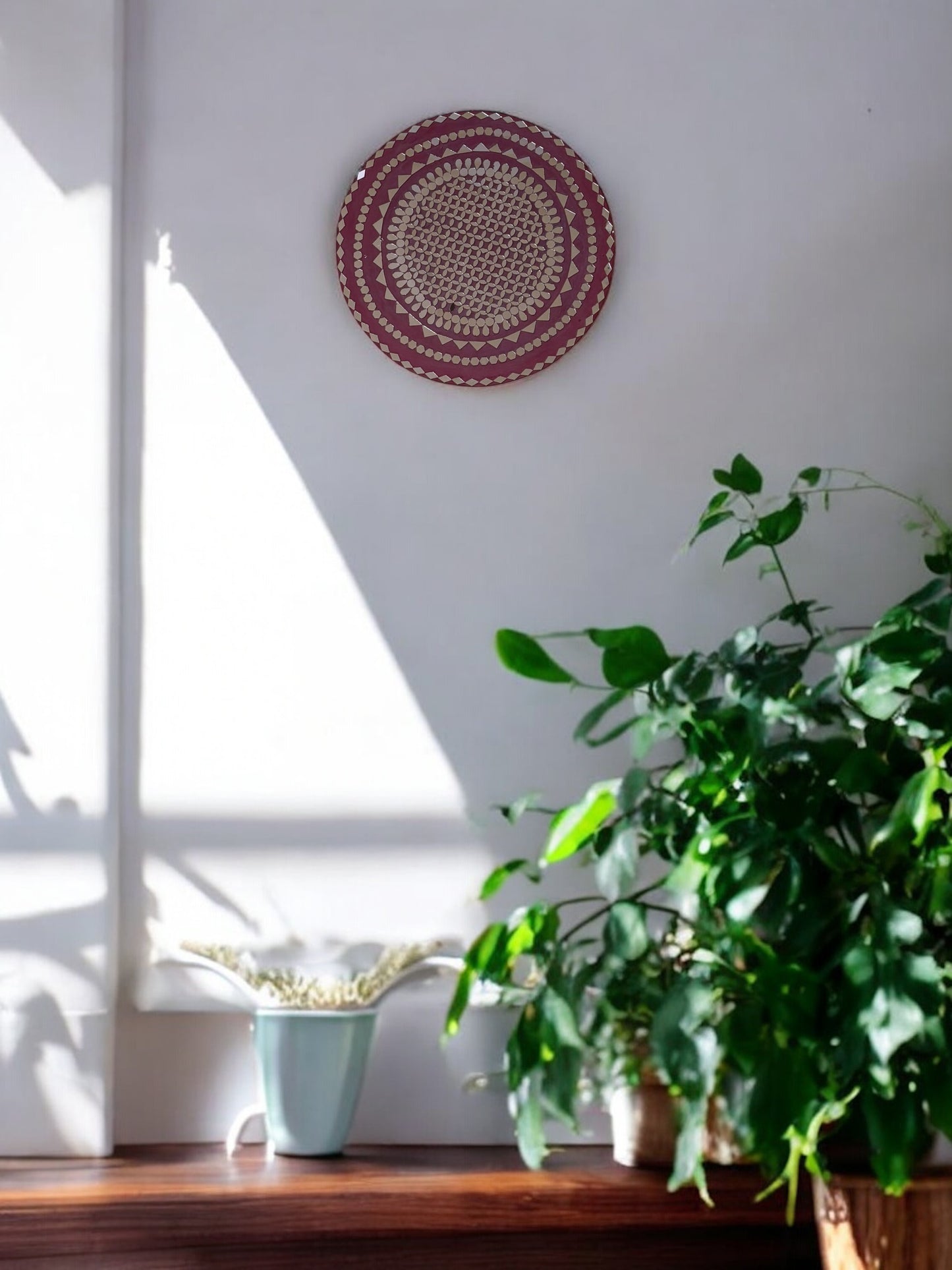 Full front view of Raspberry Mandala round mosaic wall mirror by Mirroza on a plain background.