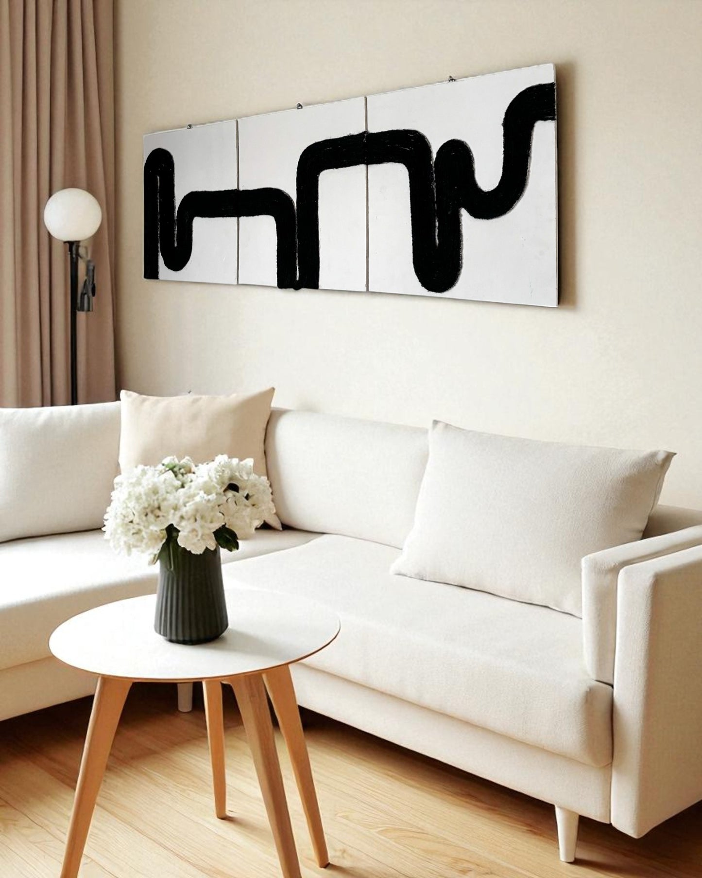 Right side view of Waves of Thought rope wall art in a minimalist beige living room with white sofa and warm lighting, highlighting the texture and flow of the black rope design