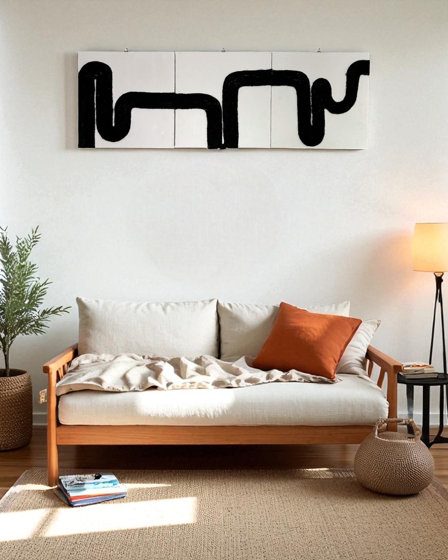Minimalist boho space with black rope wall art above a beige wall, complemented by indoor plants and light wood accents.