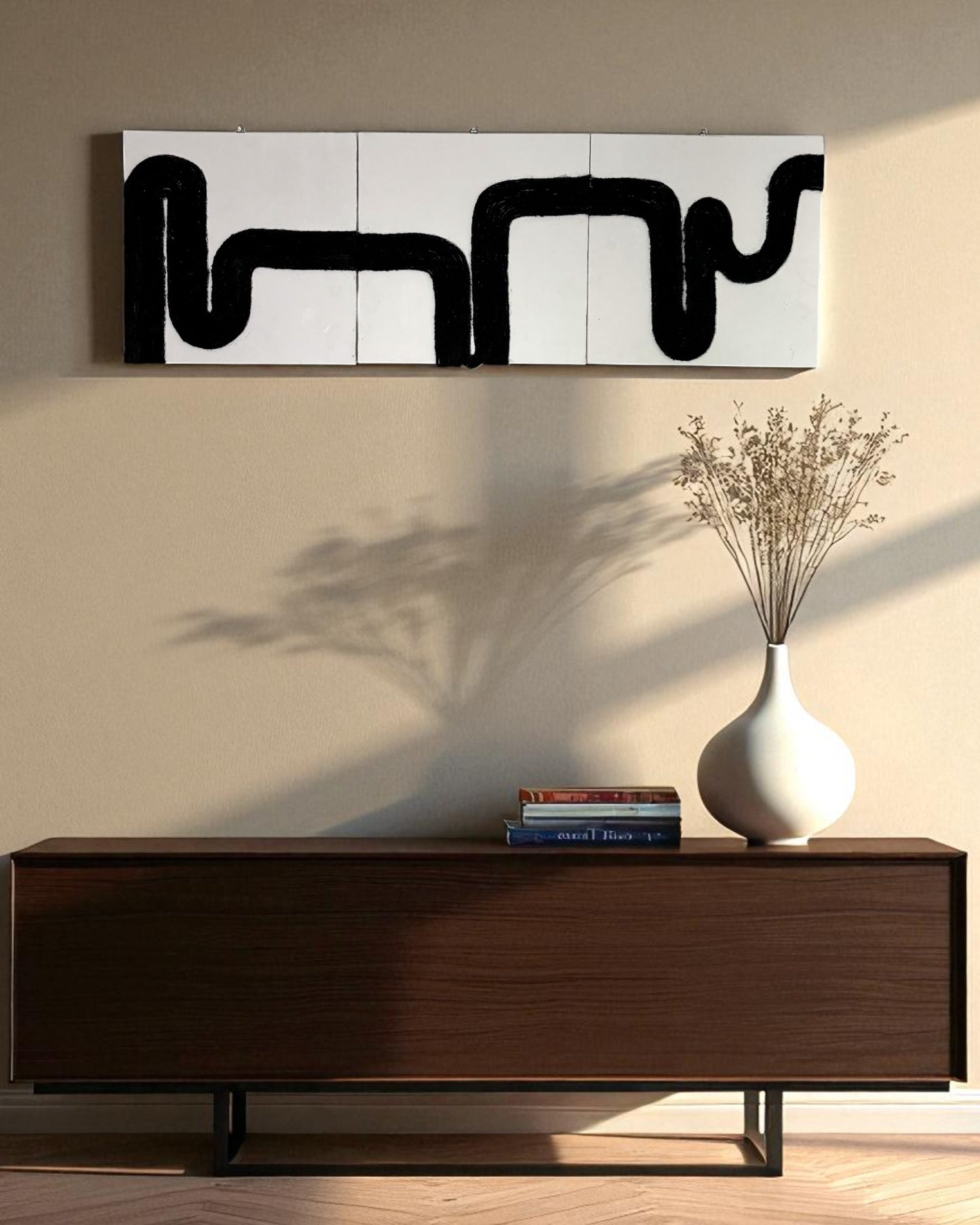 Waves of Thought’ three-piece black rope wall art displayed vertically on a light beige wall above a modern console table in a minimalist entryway