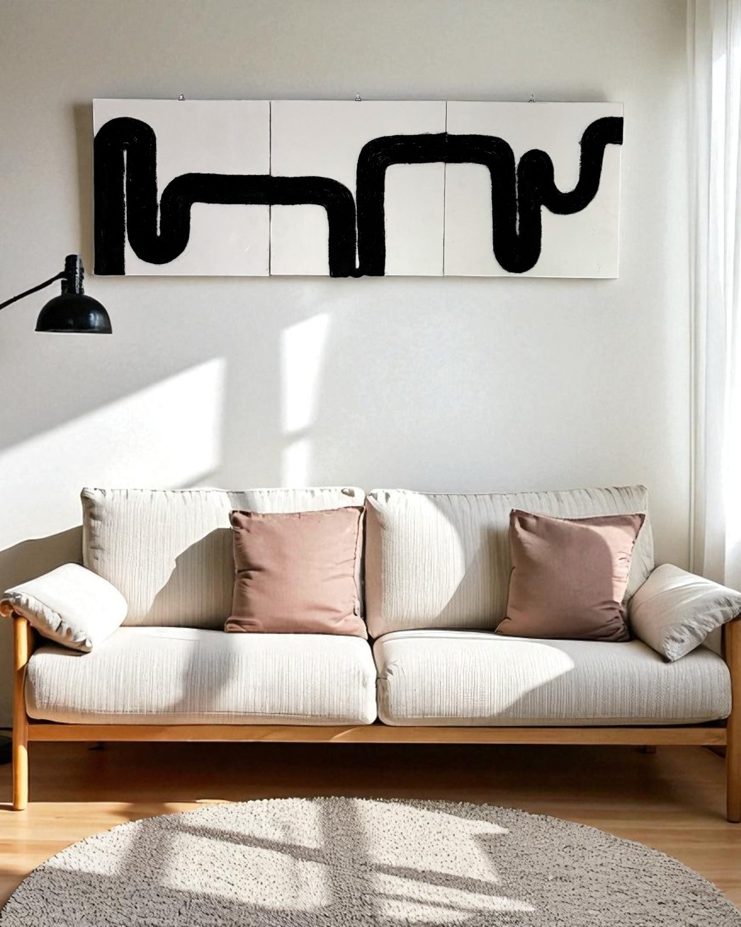 Three-piece black rope abstract wall art titled ‘Waves of Thought’ displayed above a beige mid-century sofa in a Scandinavian-style living room with light wood flooring and soft natural lighting
