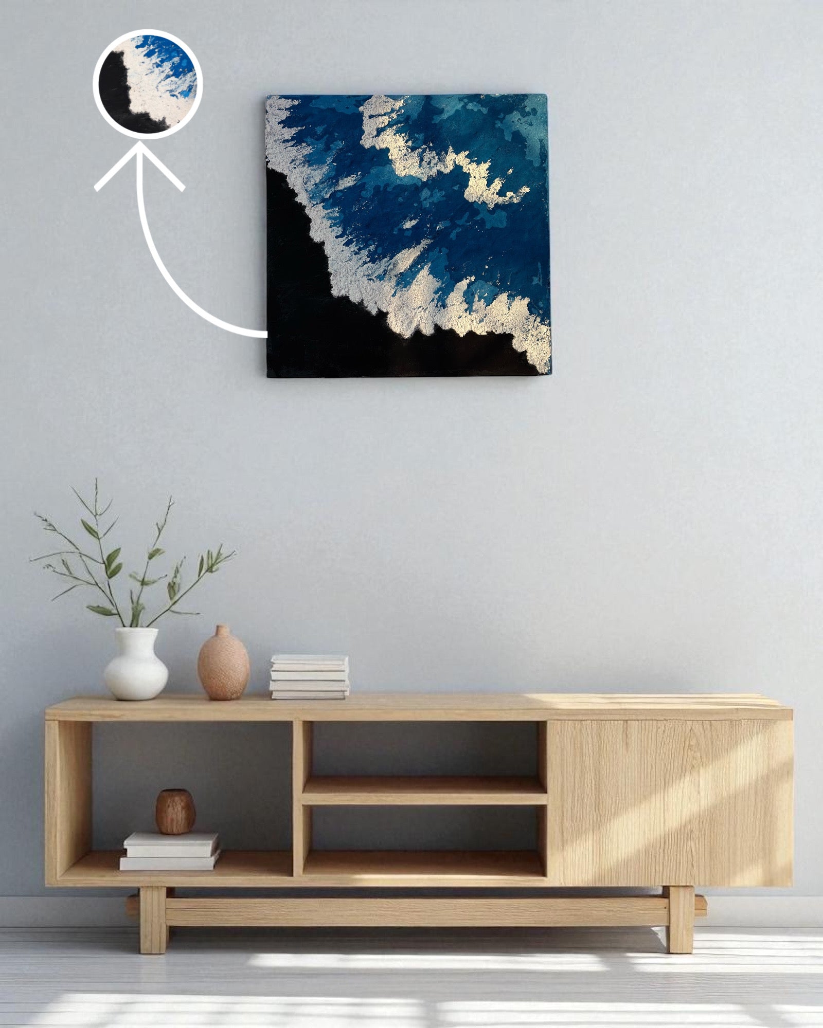 Modern living room with a wooden TV stand, decorative items, and a large abstract painting on the wall.