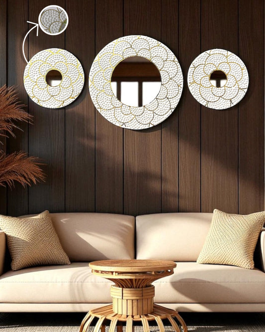 Decorative wall mirrors on a wooden wall above a beige sofa.