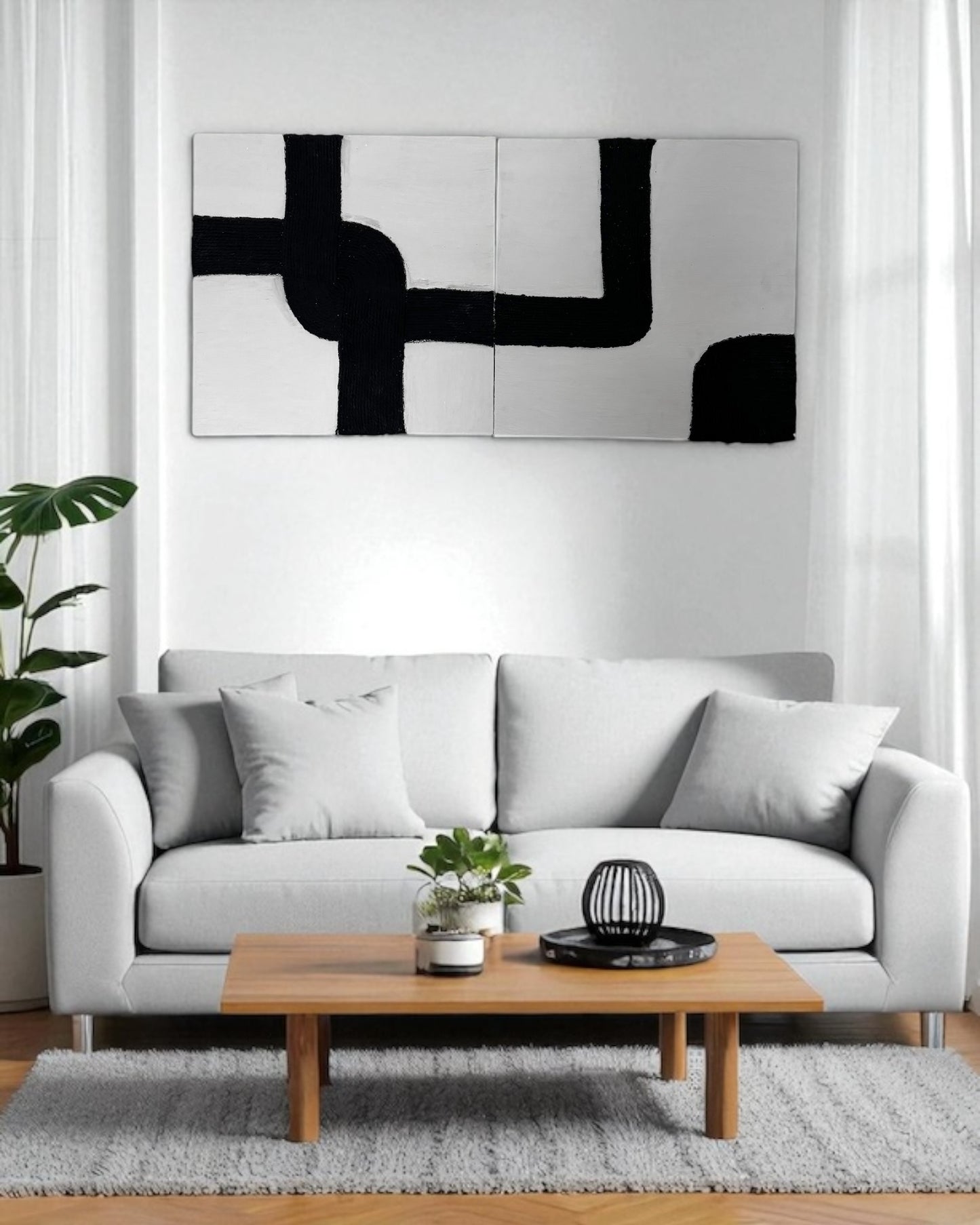 Two-piece black and white rope abstract wall art displayed on a warm gray wall in a luxury hallway with accent lighting