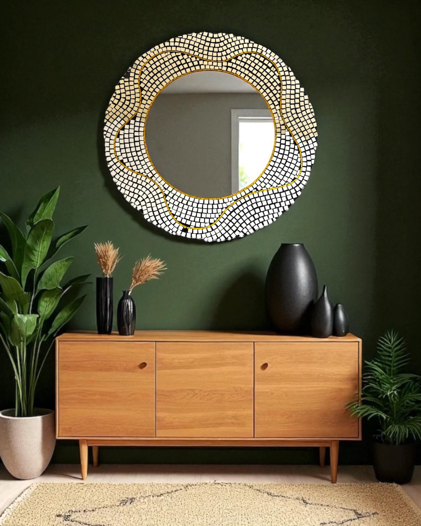 round mosaic mirror with a beaded frame on a green wall above a wooden console table.