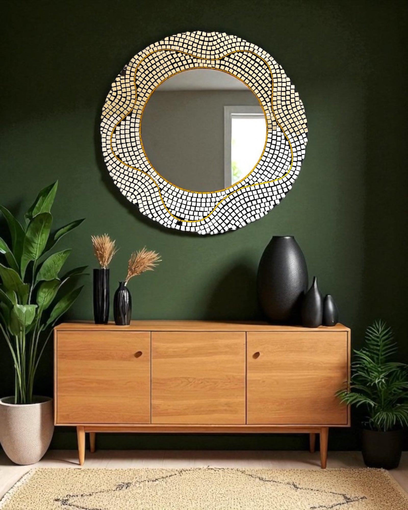 round mosaic mirror with a beaded frame on a green wall above a wooden console table.