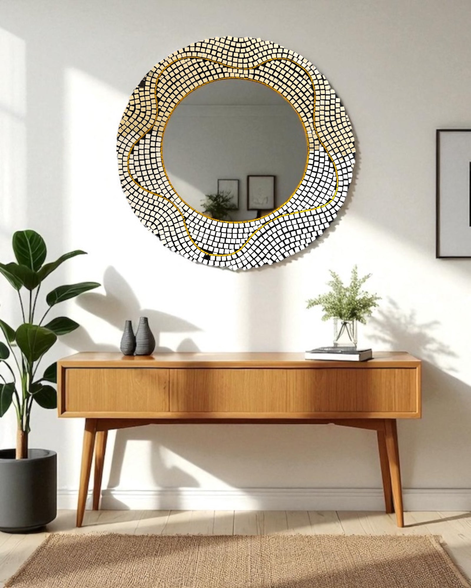 Round decorative mosaic mirror with a gold frame above a wooden console table in a room.