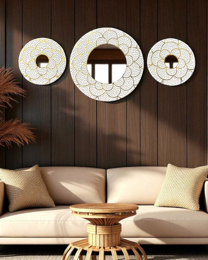 Decorative wall mirrors on a wooden wall above a beige sofa.