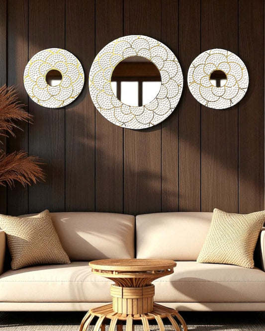 Decorative wall mirrors on a wooden wall above a beige sofa.