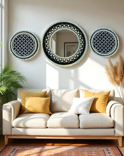 Three mosaic decorative mirrors on a wall above a beige sofa with yellow and white cushions.