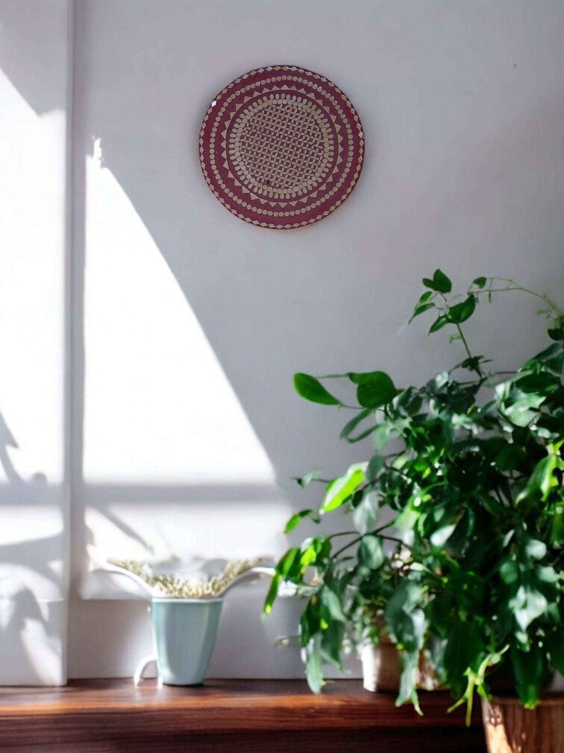 Full front view of Raspberry Mandala round mosaic wall mirror by Mirroza on a plain background.